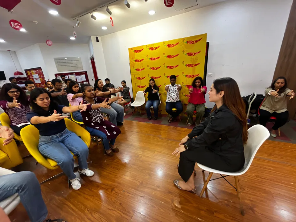 Workshop participants seated in a semicircle taking part in a guided group exercise.